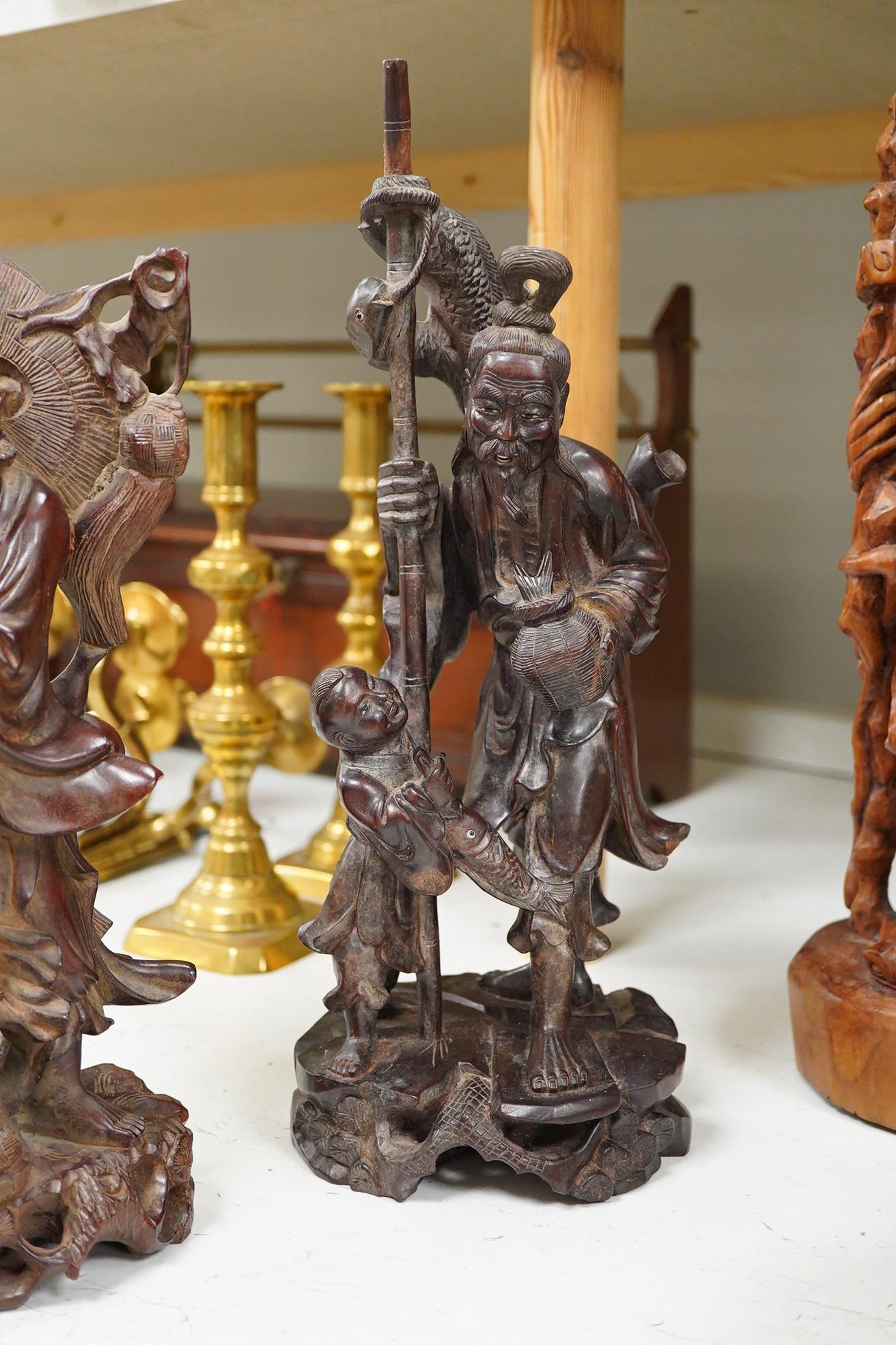 Three Chinese carved wood figures; Shou Lao, a fisherman and a Luohan, tallest 39cm